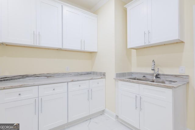166 Tempa Ln, Douglas, GA 31535 - kitchen with marble finish floor, light stone counters, a sink, and white cabinetry