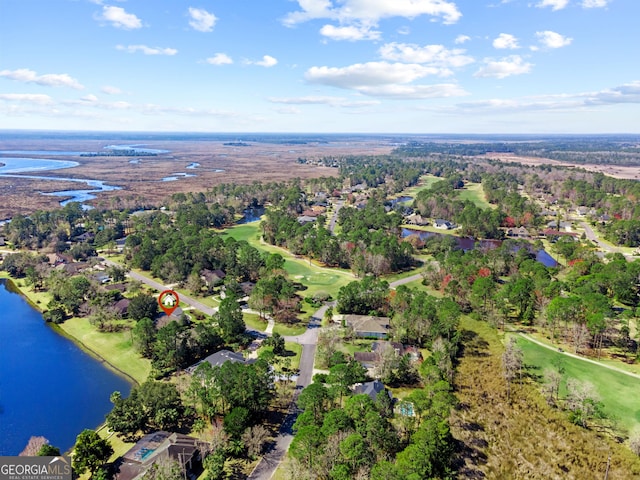 birds eye view of property with a water view and golf course view