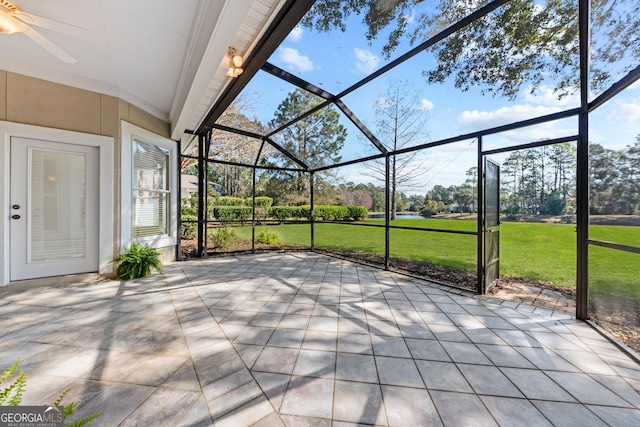 view of patio / terrace featuring glass enclosure and a ceiling fan