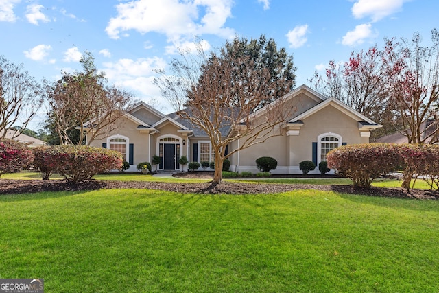 view of front of property with a front lawn and stucco siding