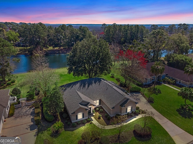 birds eye view of property with a water view