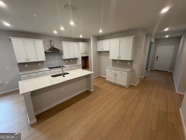 203 Park View Ln, Kingsland, GA 31548 - kitchen featuring wall chimney range hood, a sink, decorative backsplash, light wood finished floors, and recessed lighting
