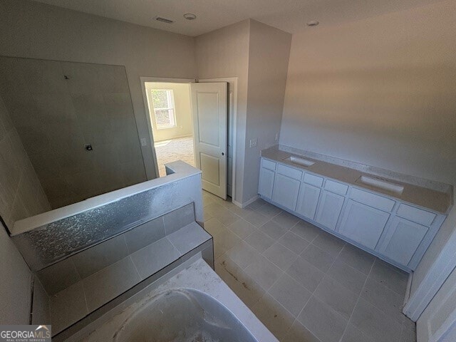 full bath featuring a tile shower, tile patterned floors, visible vents, and a bathtub