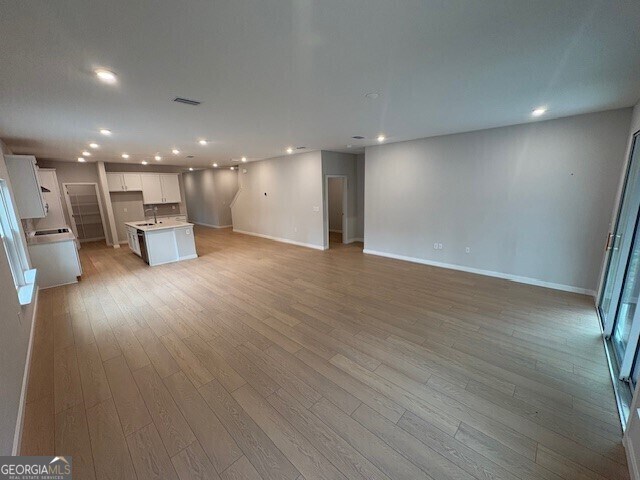 203 Park View Ln, Kingsland, GA 31548 - unfurnished living room with recessed lighting, light wood-style flooring, and baseboards