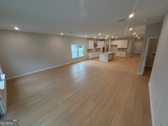 203 Park View Ln, Kingsland, GA 31548 - unfurnished living room with recessed lighting, light wood finished floors, and baseboards