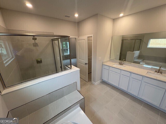 203 Park View Ln, Kingsland, GA 31548 - bathroom with a stall shower, double vanity, plenty of natural light, a bath, and recessed lighting