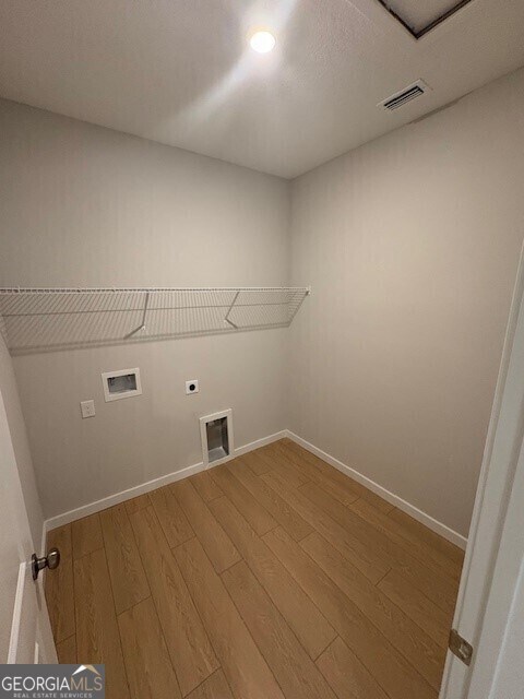 203 Park View Ln, Kingsland, GA 31548 - washroom featuring hookup for an electric dryer, wood finished floors, hookup for a washing machine, and baseboards