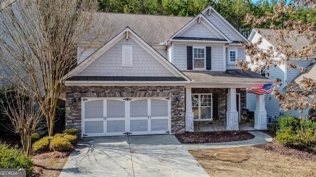 craftsman inspired home featuring a porch, stone siding, driveway, and an attached garage