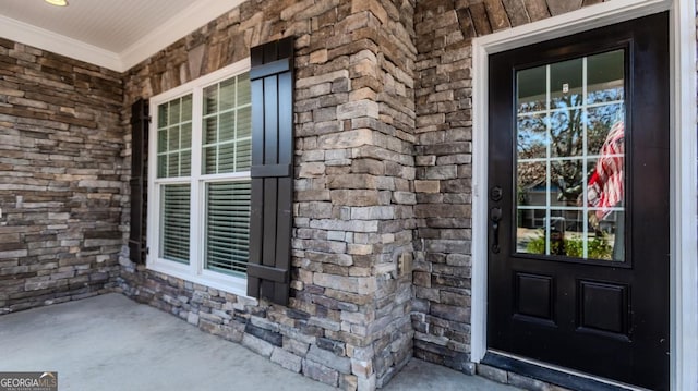 property entrance with stone siding and covered porch