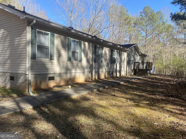 view of side of home with crawl space