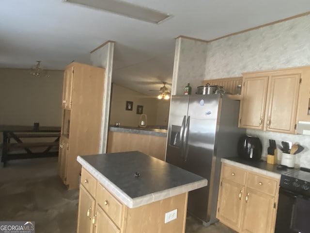 kitchen featuring ceiling fan, black range with electric cooktop, a center island, light brown cabinetry, and stainless steel fridge