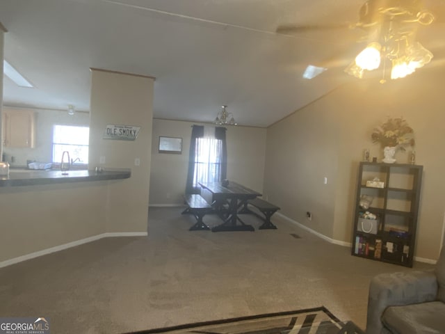 interior space with vaulted ceiling, carpet flooring, and a wealth of natural light