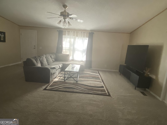 living area with carpet, vaulted ceiling, baseboards, and ceiling fan