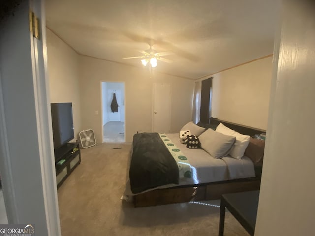 carpeted bedroom featuring vaulted ceiling and a ceiling fan