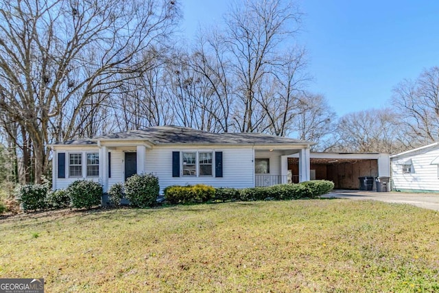 single story home with a carport, a front lawn, and concrete driveway