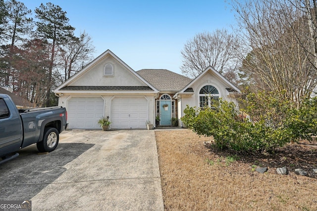 view of front of property with a garage, concrete driveway, a shingled roof, and stucco siding