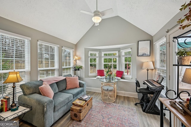 sunroom with a healthy amount of sunlight, ceiling fan, and vaulted ceiling