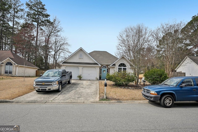 view of front of property featuring an attached garage and driveway