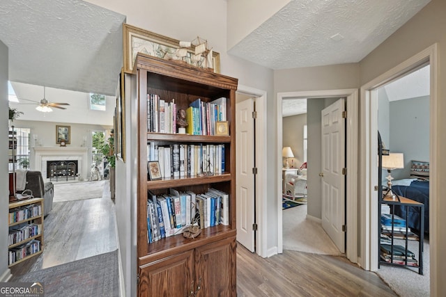 hallway featuring a textured ceiling and wood finished floors