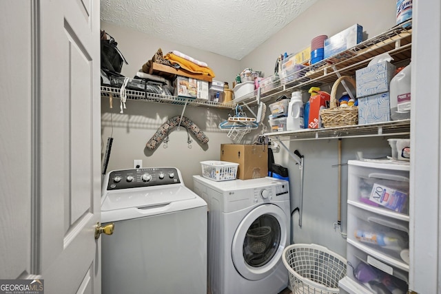 laundry area with laundry area, a textured ceiling, and independent washer and dryer