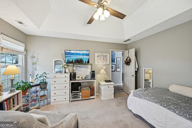 bedroom featuring ceiling fan, carpet, visible vents, and vaulted ceiling