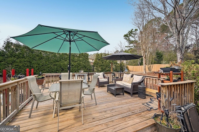 wooden terrace with fence, outdoor lounge area, and outdoor dining space