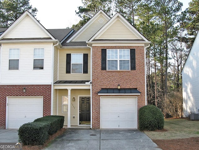 view of property featuring concrete driveway, brick siding, and an attached garage