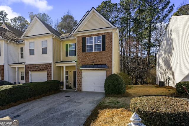 view of front of property with driveway, a garage, and brick siding