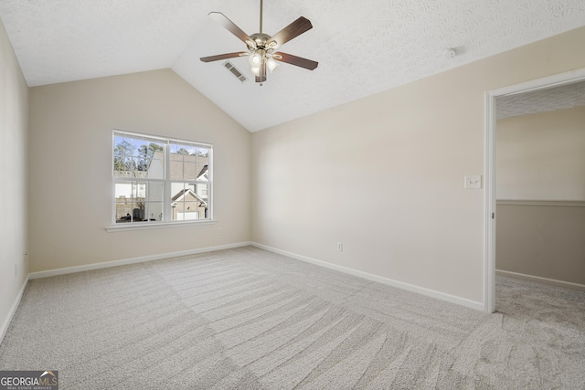 unfurnished bedroom featuring lofted ceiling, carpet floors, and a textured ceiling