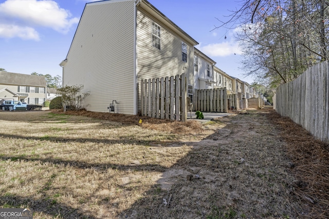 view of side of home featuring fence