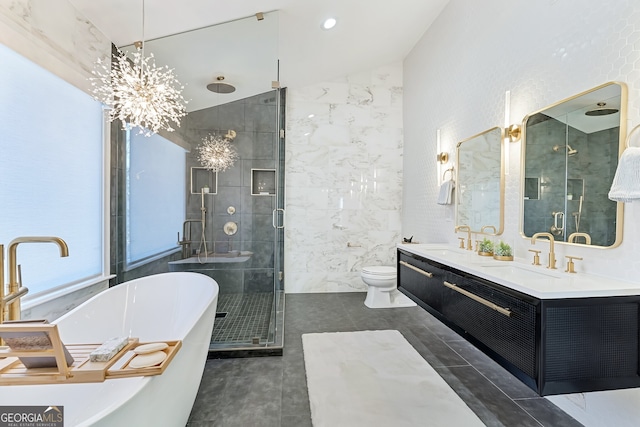 bathroom with tile walls, vaulted ceiling, a sink, a shower stall, and a freestanding tub