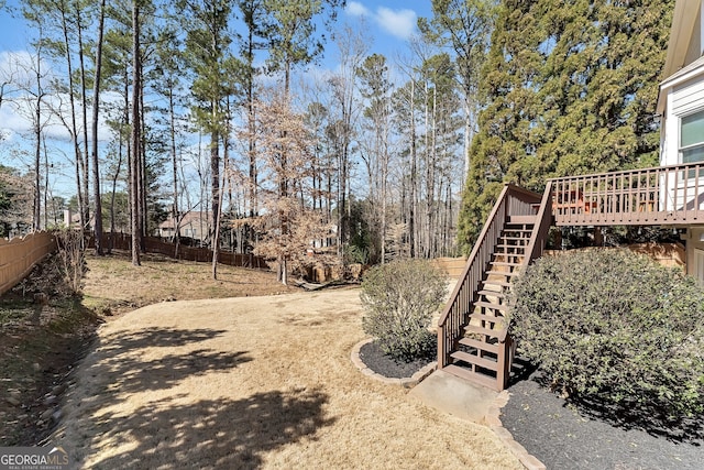 view of yard featuring stairway, fence, and a wooden deck