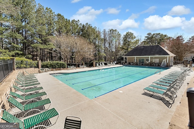 pool featuring a patio and fence