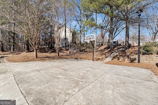 view of sport court featuring community basketball court and stairway