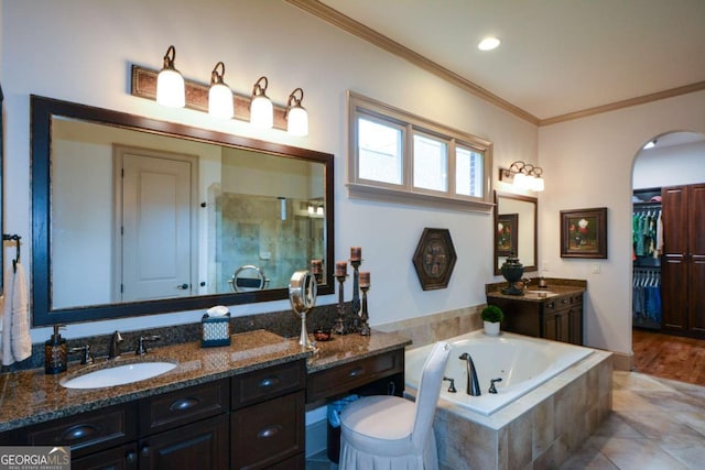 bathroom with ornamental molding, a stall shower, vanity, a bath, and tile patterned floors