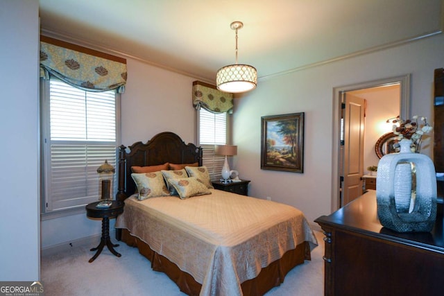 bedroom with light carpet and crown molding