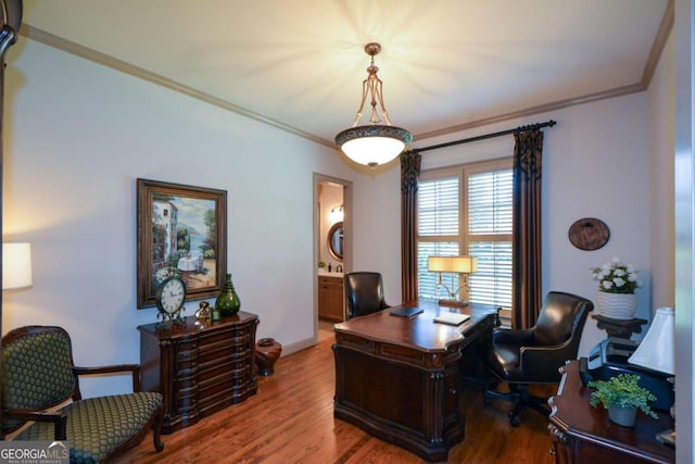 office featuring ornamental molding, baseboards, and wood finished floors