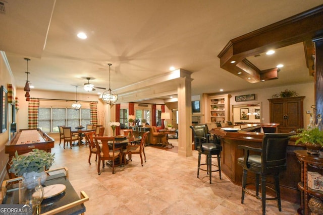 dining area with ceiling fan, recessed lighting, visible vents, a bar, and ornate columns