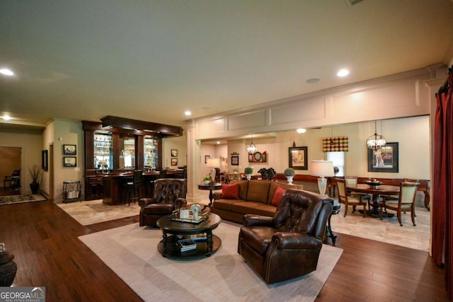 living area featuring an inviting chandelier, wood finished floors, and recessed lighting