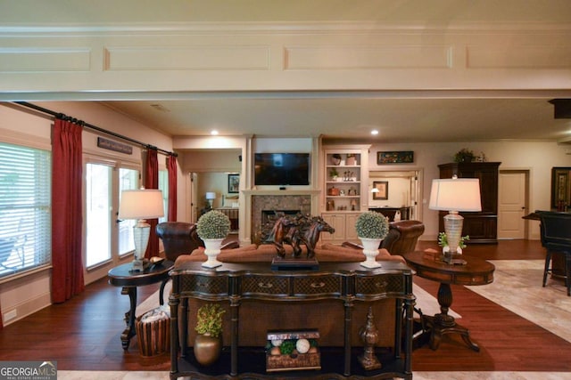 living room with a fireplace and wood finished floors