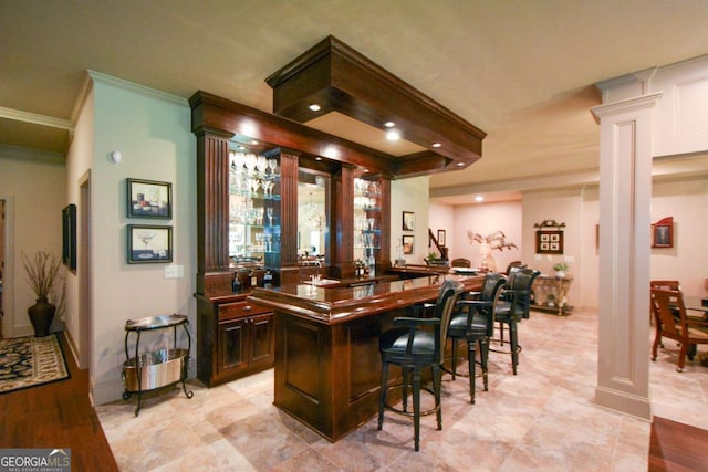 bar featuring decorative columns, wet bar, ornamental molding, and recessed lighting