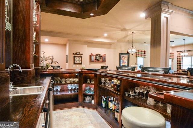 4880 Cecilia Sq, Cumming, GA 30040 - bar area with crown molding, recessed lighting, ornate columns, and hanging light fixtures