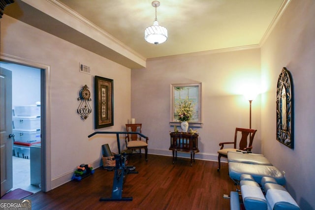 exercise room with ornamental molding, wood finished floors, visible vents, and baseboards