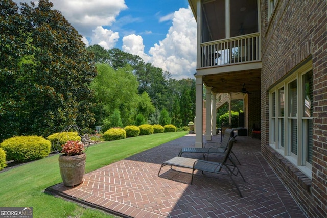 view of patio / terrace featuring ceiling fan and a balcony