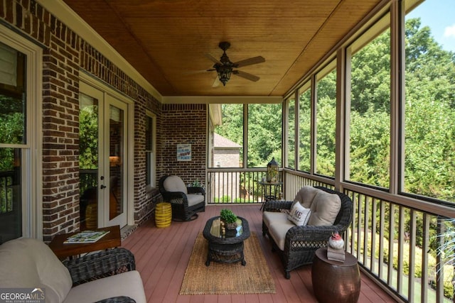 sunroom featuring wood ceiling, ceiling fan, and french doors