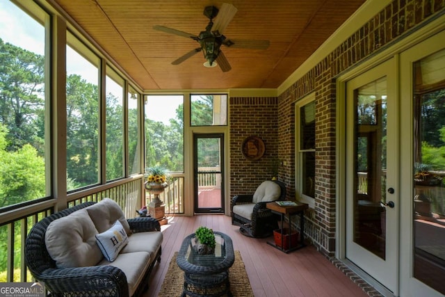 sunroom / solarium featuring wood ceiling and ceiling fan