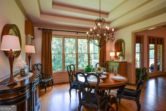 4880 Cecilia Sq, Cumming, GA 30040 - dining area featuring wood finished floors, a chandelier, crown molding, a wainscoted wall, and a tray ceiling