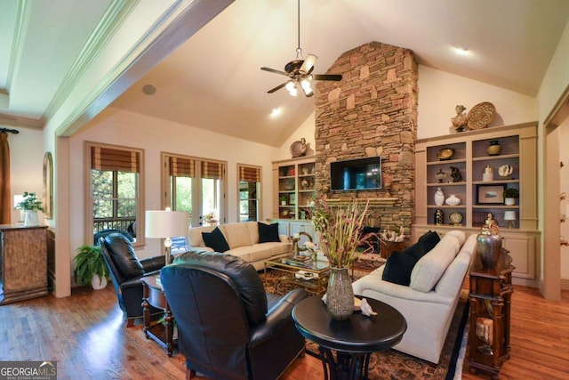 living room featuring high vaulted ceiling, a stone fireplace, wood finished floors, and a ceiling fan