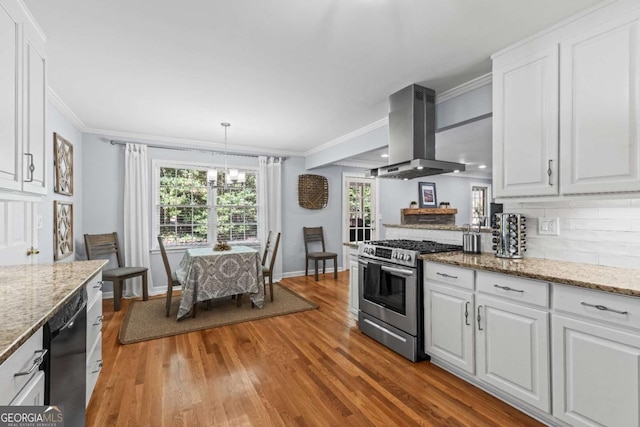 kitchen featuring stainless steel gas range, light wood-type flooring, white cabinets, and island exhaust hood