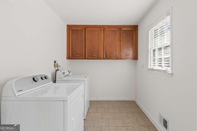 laundry area featuring cabinet space, washing machine and dryer, visible vents, and baseboards